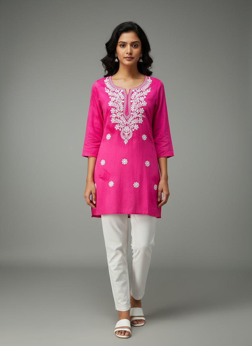 model is wearing this short length hot pink colour kurti in tie & dye colour with white machine embroidery by famaza couture