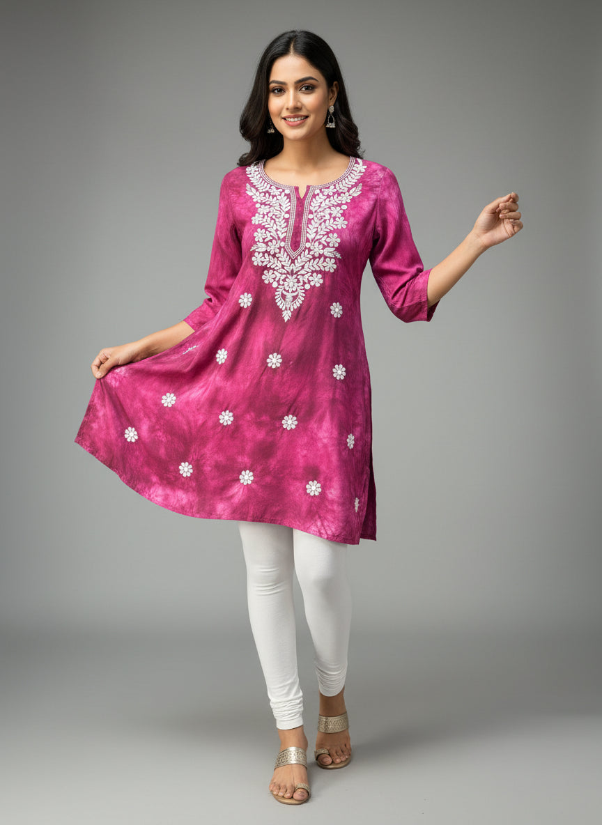 model is wearing this short length purple colour kurti in tie & dye colour with white machine embroidery