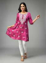 model is wearing this short length purple colour kurti in tie & dye colour with white machine embroidery