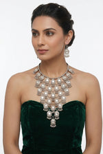 Model wearing the Moonlit Embrace silver-tone cascading necklace and drop earrings with a dark green strapless outfit