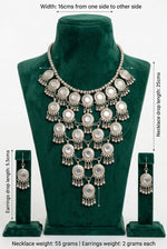 Moonlit Embrace necklace and earrings measurement chart showing listed dimensions and weights on a green velvet display