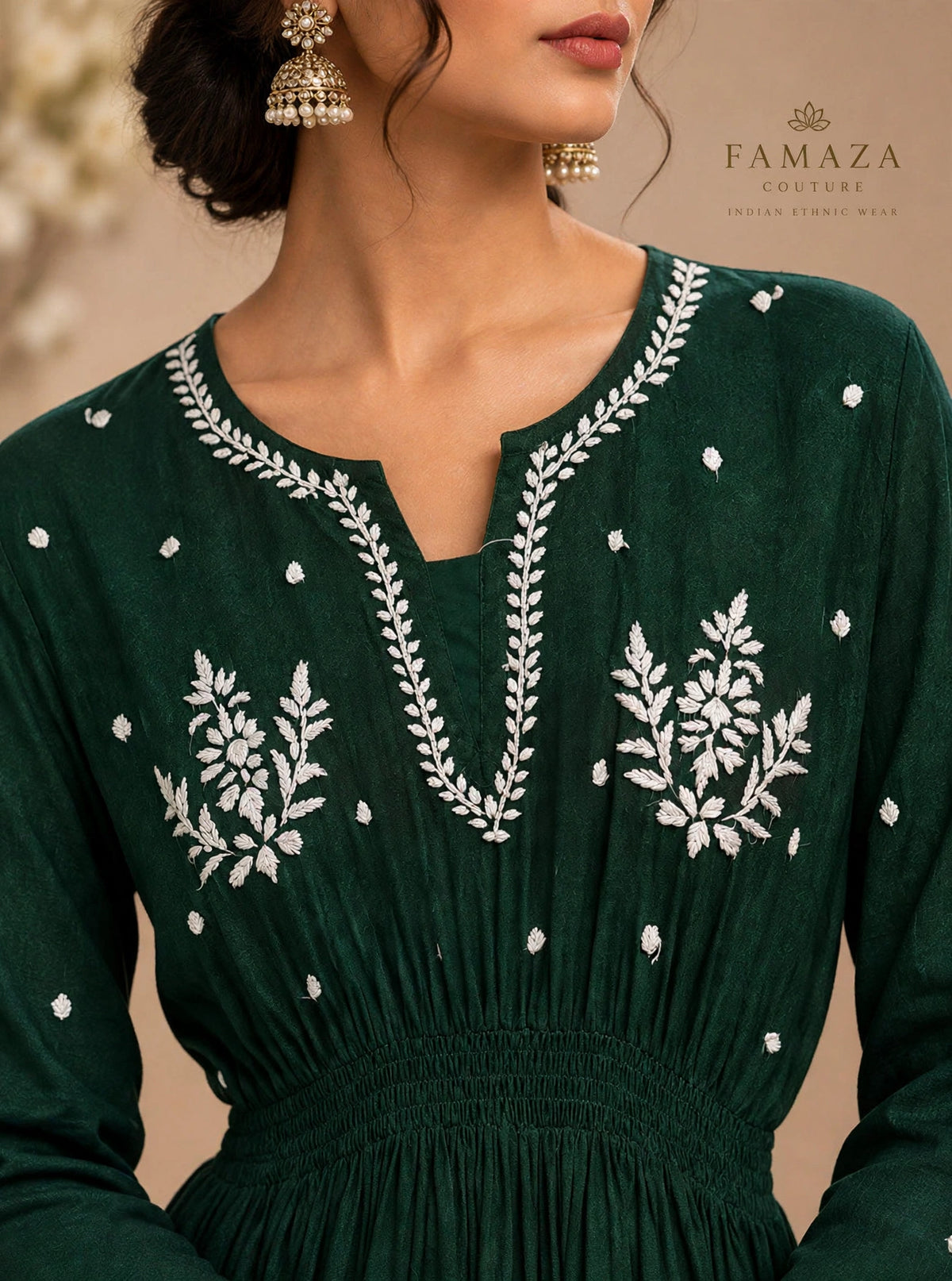A bottle green long-sleeve dress with white floral embroidery around the V-neckline and on the chest.