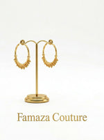 Pair of luxury 18K gold-plated Chand Bali hoop earrings with intricate beaded drops, displayed on a gold stand for Famaza Couture.