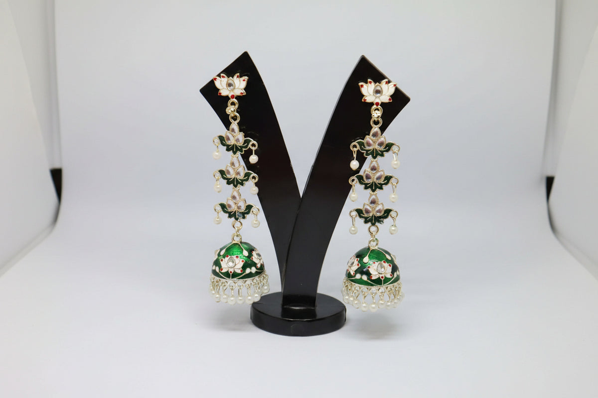 pair of bottle green colour silver-plated tulip-shaped long jhumka earrings with multicolour details, displayed on a black stand.