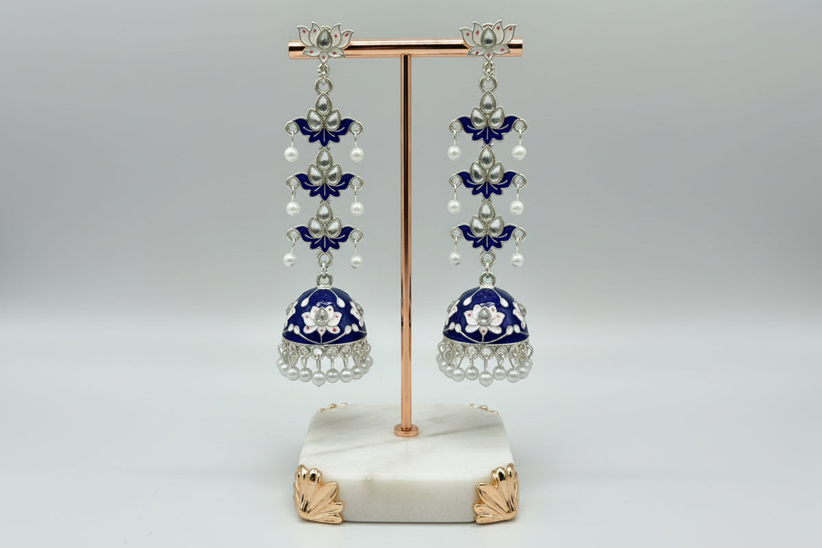 pair of navy blue colour silver-plated tulip-shaped long jhumka earrings with multicolour details, displayed on a black stand.