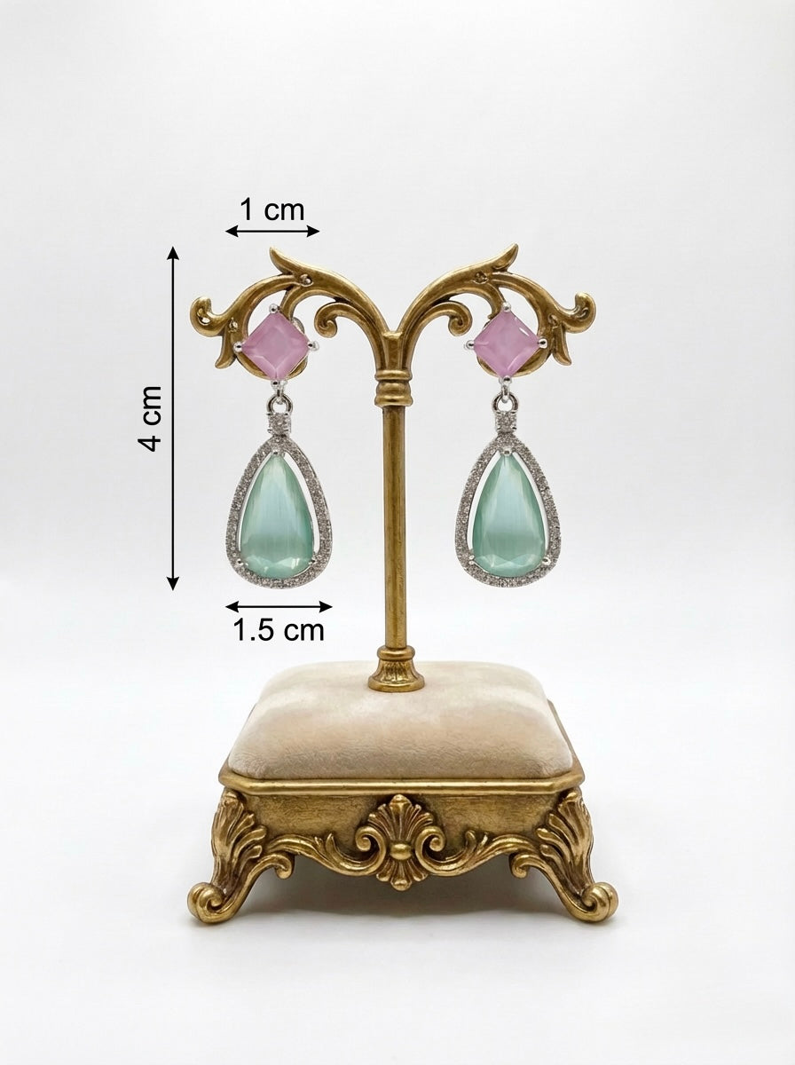 pink and sea green foam colour teardrop earrings on a decorative stand with measurements.