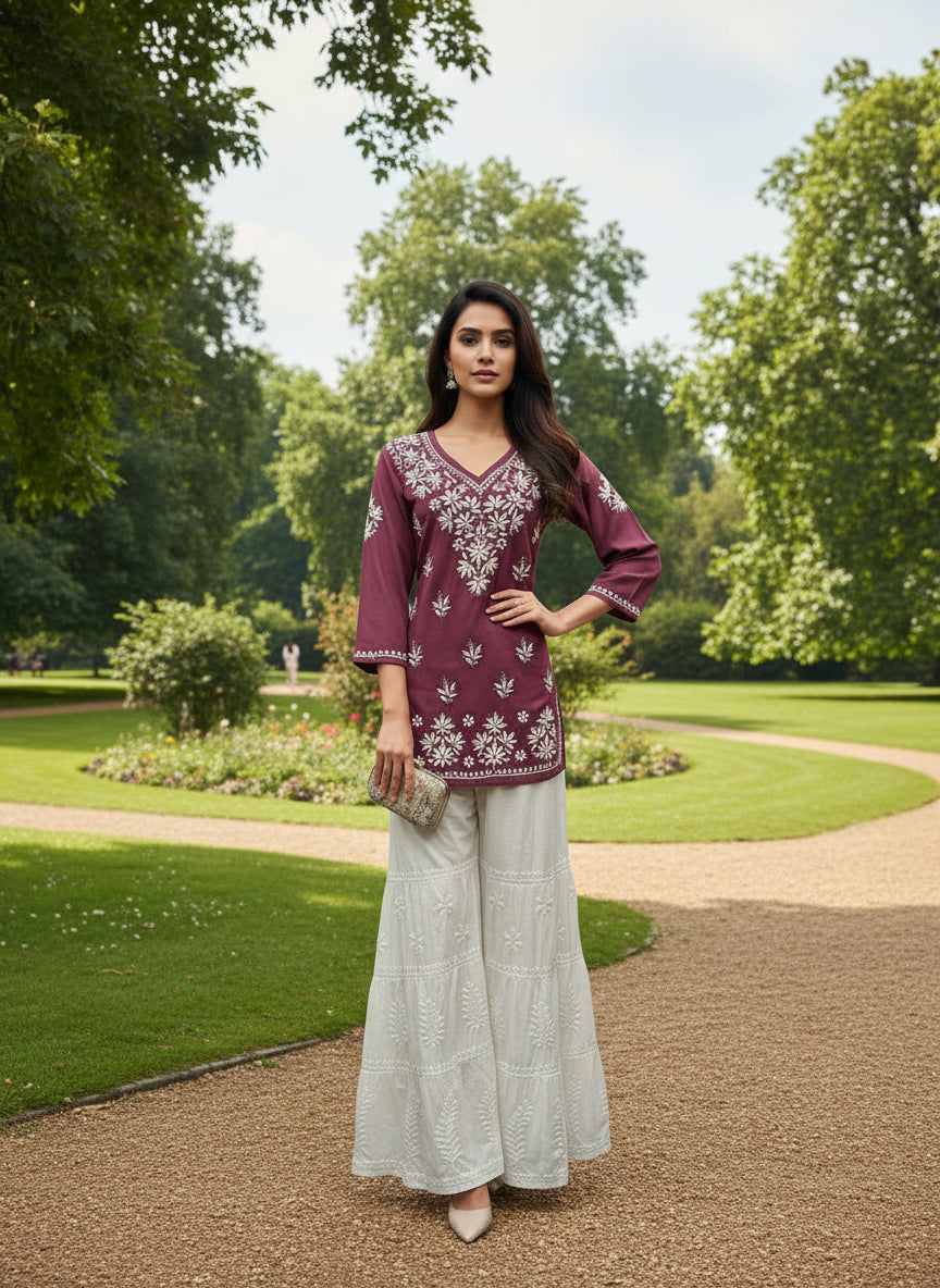 Mannequin wearing a purple short shirt with white patterns pants in a store setting.