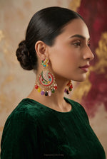 Multicolour chandbali earrings on a black stand, showing gold-tone frames, curved bead rows, faux pearls and colourful bead drops.
