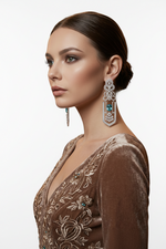 Intricate diamond chandelier earrings with light blue-green stone