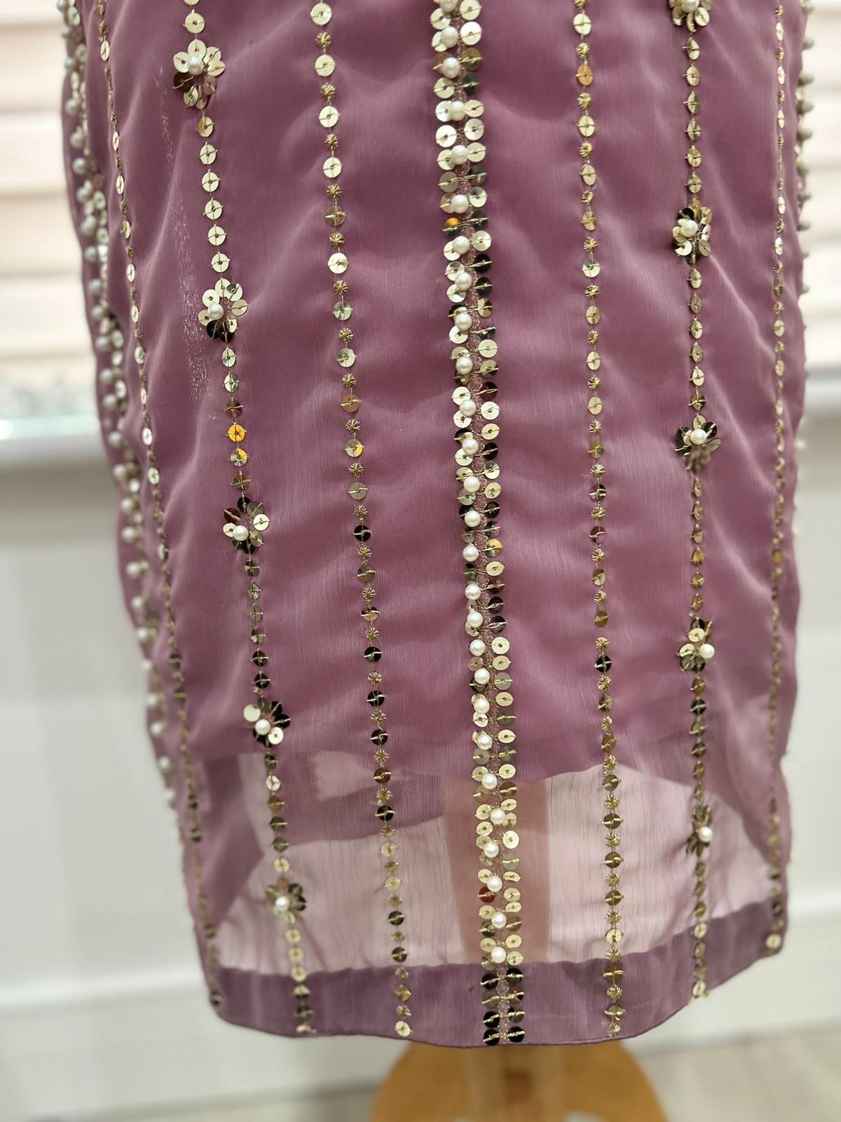 Close-up of the Shan-e-Sheeba lavender shirt hem showing vertical sequin rows, floral embellishments and a sheer chiffon border.