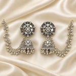 Oxidised silver-tone Bahubali jhumka earrings with mirror-work and Sahara chains on cream fabric