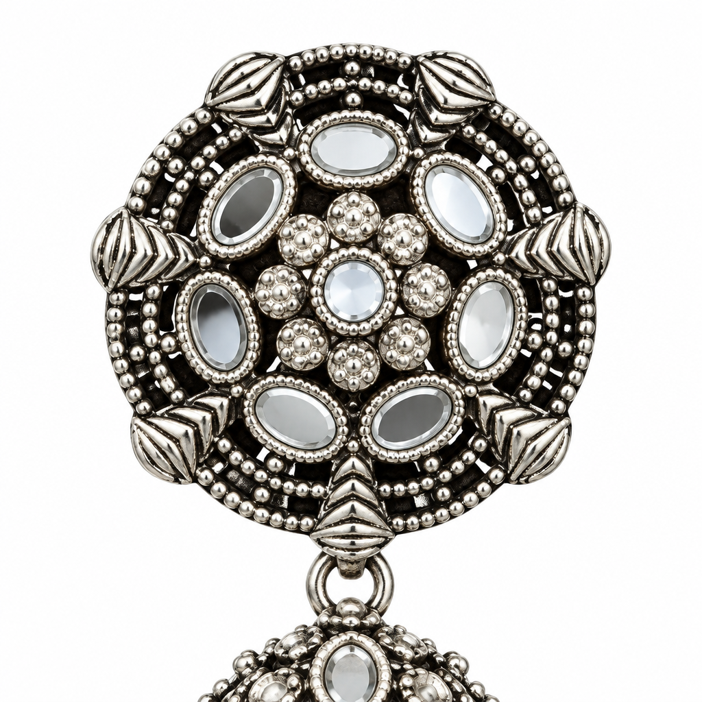 Close-up of the round mirror-work stud on an oxidised silver-tone Bahubali jhumka earring