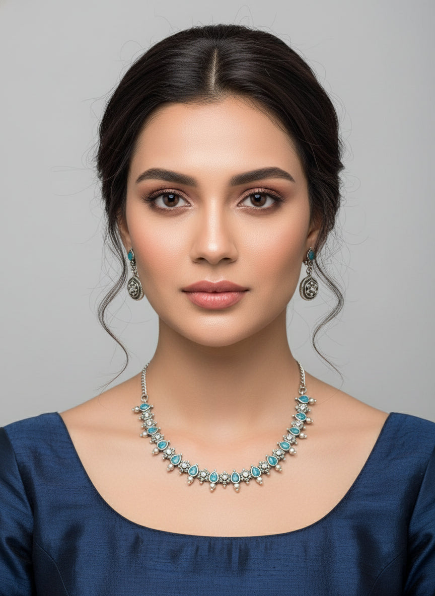 silver oxidised Jewellery set with necklace and earrings with blue stones in centre by famaza couture