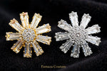 Close-up of the gold-tone and silver-tone starburst earring tops with clear tapered stones surrounding round centres