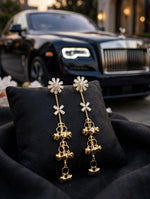 Gold-tone and silver-tone Starlit Melody long ghungroo earrings on Famaza Couture display cards against black velvet