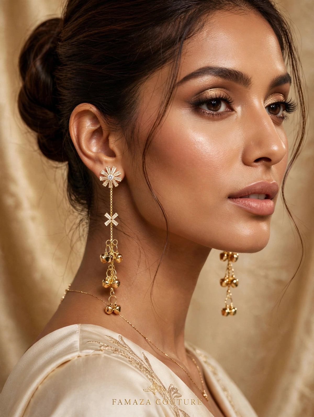 Model in a cream outfit wearing gold-tone Starlit Melody earrings with starburst tops and cascading ghungroo bells