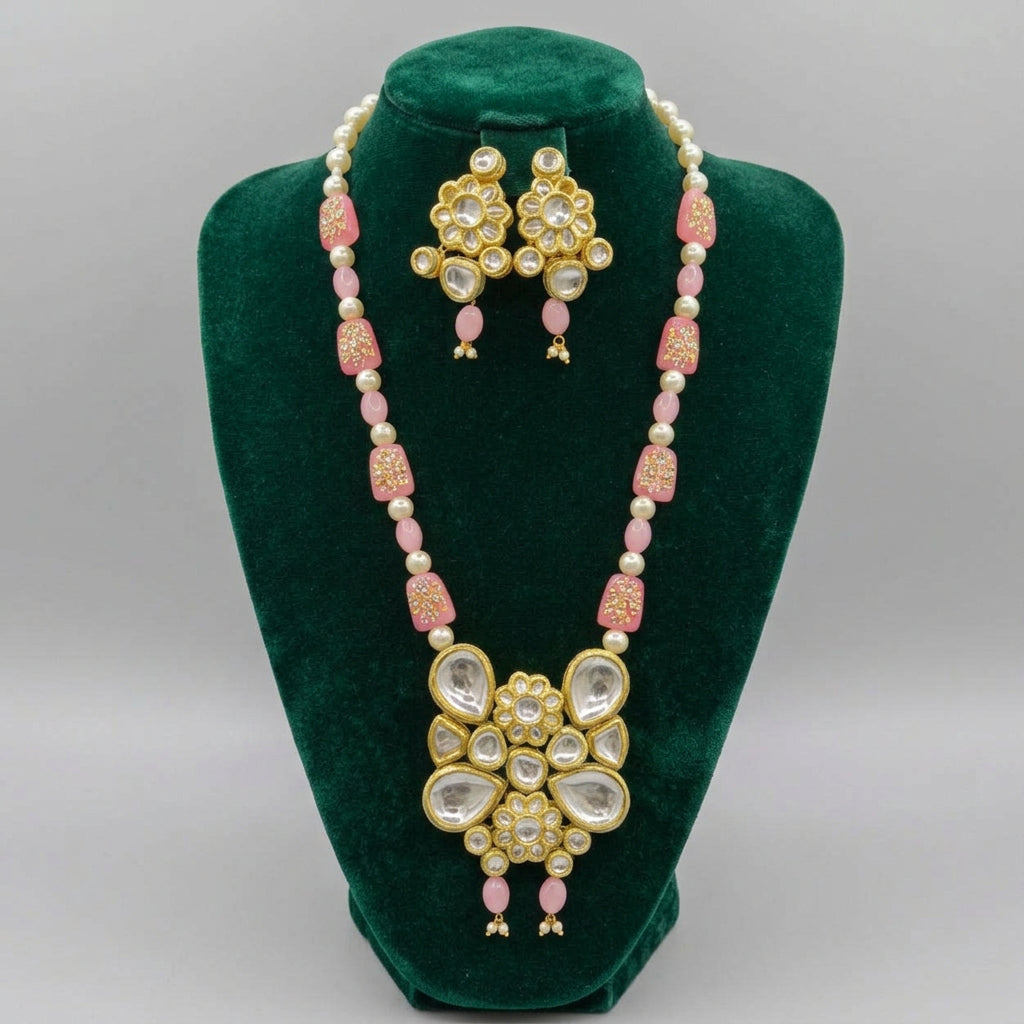 Pink and cream beaded Kundan Rani Mala necklace with a floral pendant and matching earrings on a black bust.