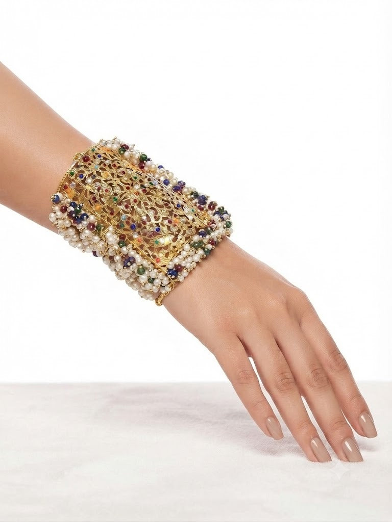 The Empress Jodha Navratna Pearl & Royal Gold Cuff bracelet by Famaza Couture, featuring a traditional Mughal-style bridal design