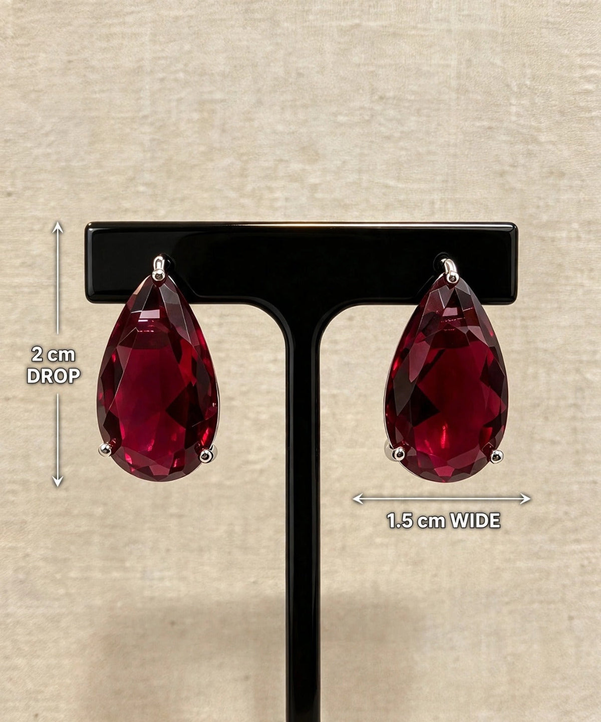 Ruby red teardrop crystal earrings with measurements showing 2 cm length and 1.5 cm width.