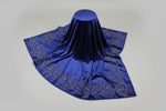 Navy velvet scarf draped on a stand, showing the floral stone-work border.