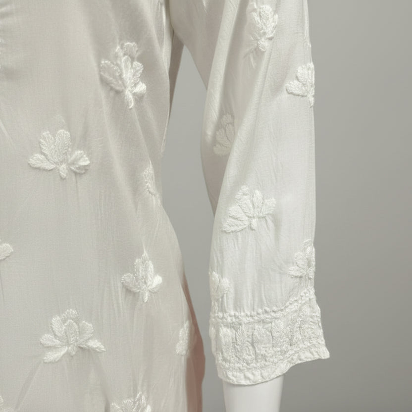 whiteMuslin fabricwith collar Chikankari short length kurti and three buttons on the front, featuring intricate ghasspati hand embroidery with floral motifs by famaza couture