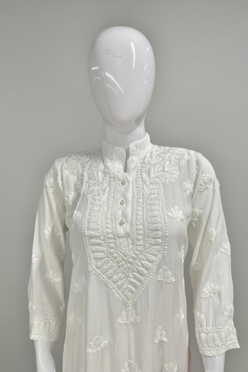 white colour Muslin fabricwith collar Chikankari short length kurti and three buttons on the front, featuring intricate ghasspati hand embroidery with floral motifs by famaza couture