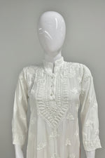 white colour Muslin fabricwith collar Chikankari short length kurti and three buttons on the front, featuring intricate ghasspati hand embroidery with floral motifs by famaza couture