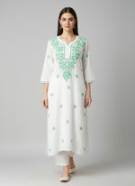 A white long kurti with green coloured embroidery