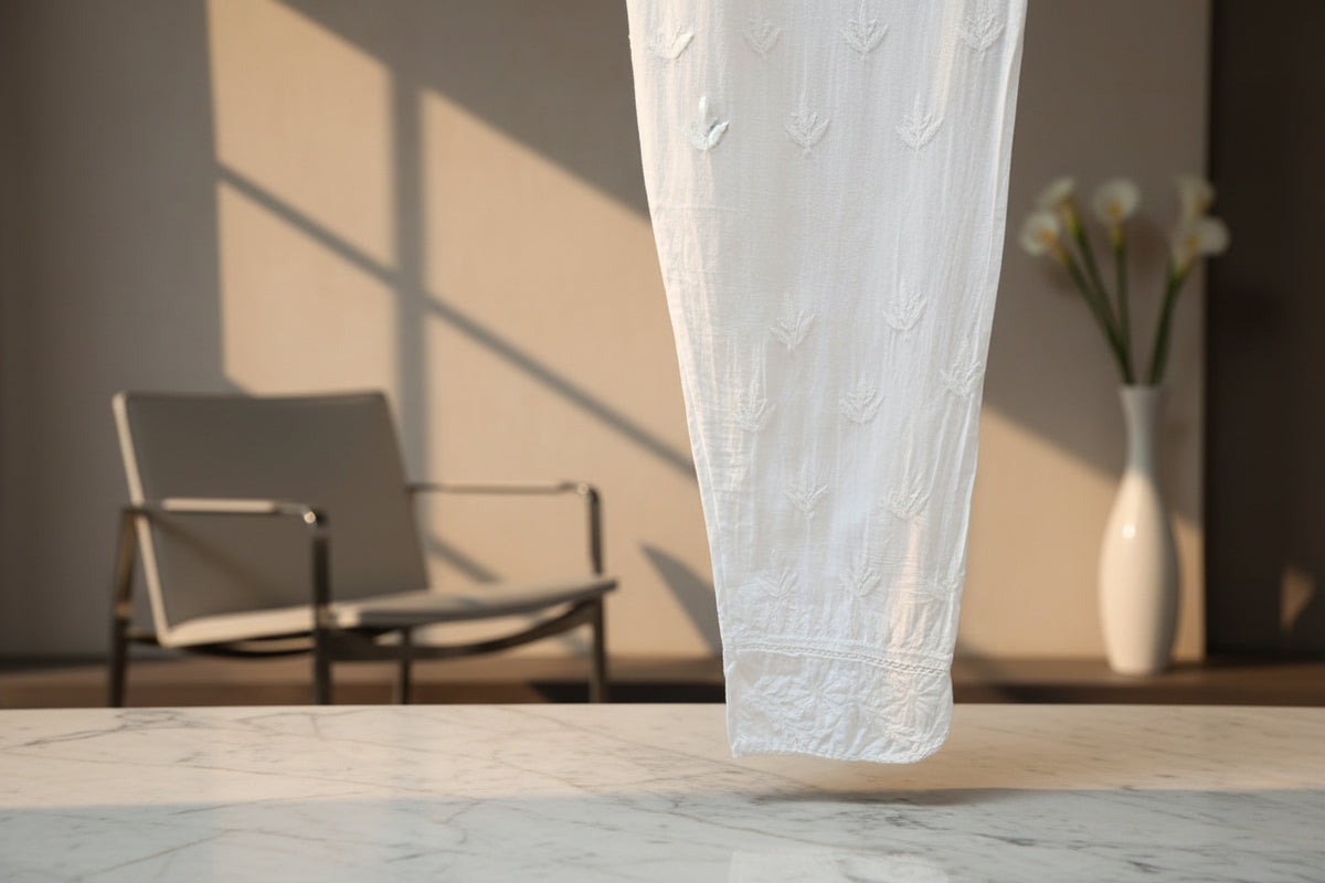 white mulmul fabric straight loose pnats with white hand embroidered with ankle cut design.By famaza Couture