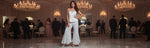 Woman in a white top with white flared pants