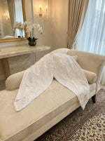 white tulip salwar is displaying on the sofa