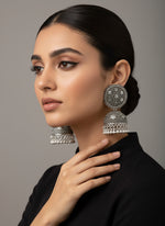 Model wearing silver oxidised teardrop filigree earrings