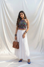 A full-length view showing the majestic 172-inch fluid flare and sweeping volume of the heavy Pearl White tiered handcrafted skirt.