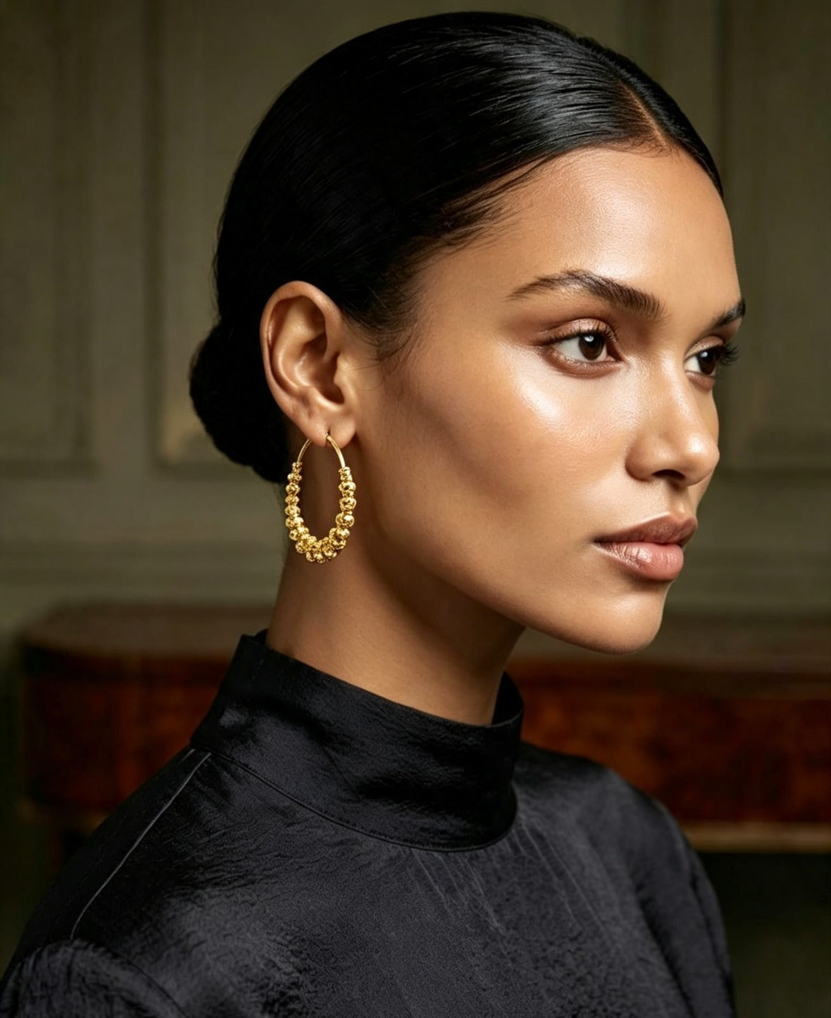 Model wearing 22K gold-plated beaded hoop earrings with graduated filigree beads, chand bali inspired design, luxury finish — Famaza Couture premium Pakistani jewellry.
