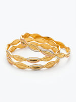 A set of four three-tone micro gold-plated copper bangles featuring an intricate floral lattice and scalloped eyelet design in yellow, white, and pink gold, displayed against a clean white background.