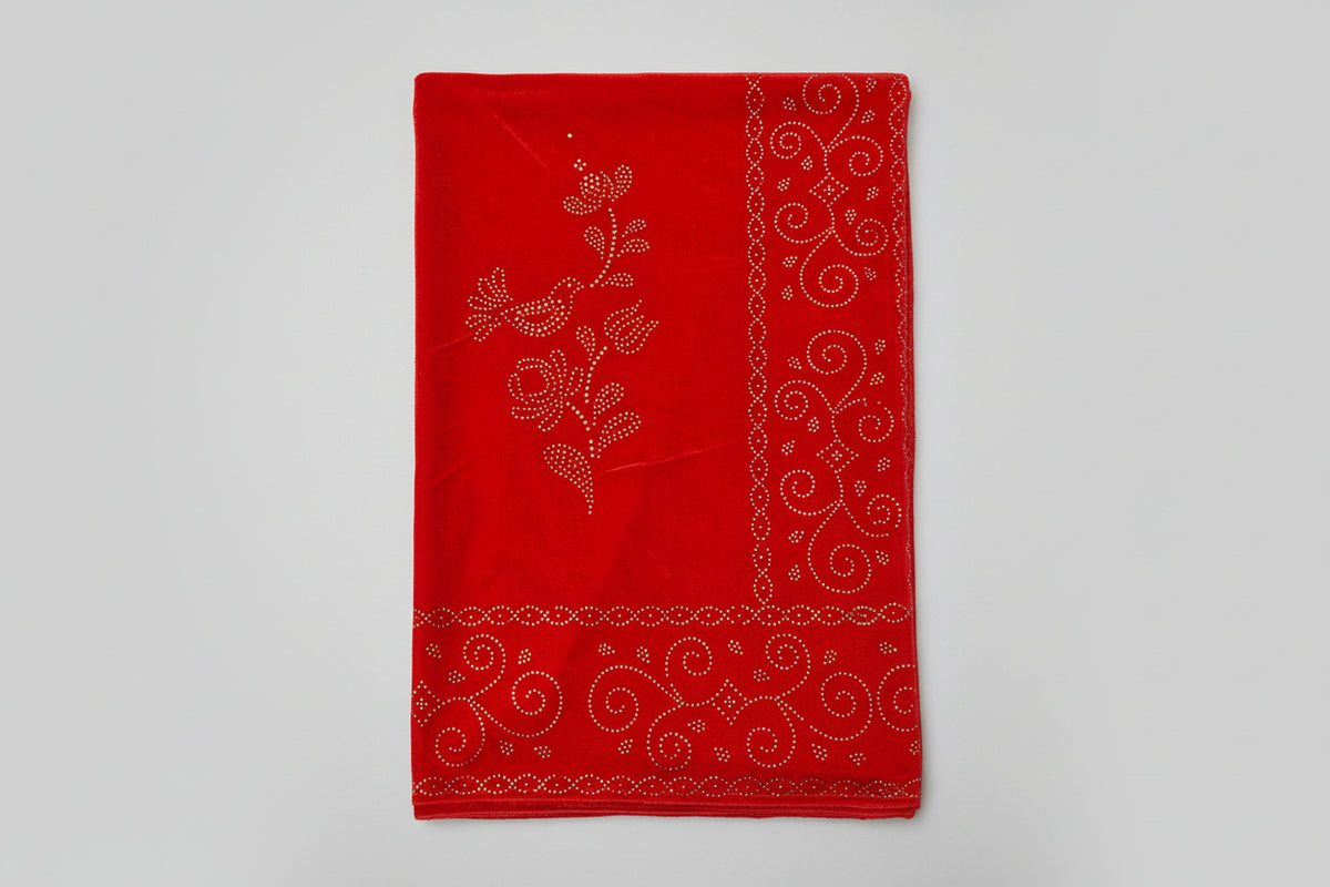 A Close-up of a red velvet stole with golden stone work and intricate patterns, showcasing its texture and glamour.