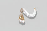 A Close-up of a woman wearing a white beaded earring with rose gold accents jhumkey.