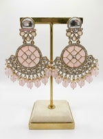 Elegant baby pink traditional earrings featuring intricate Kundan-style work and delicate pearl accents.
