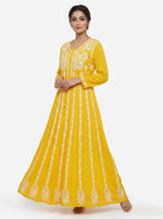 A Model is showing the front view of this Yellow chikankari hand embroidered Aanarkali long dress 