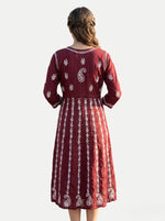 A Model is showing the rear view of this Maroon chikankari hand embroidered Aanarkali long dress.