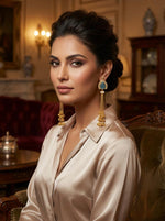 A Model is wearing 18.5cm drop length long earrings with golden nano bells hanging in the bottom. 