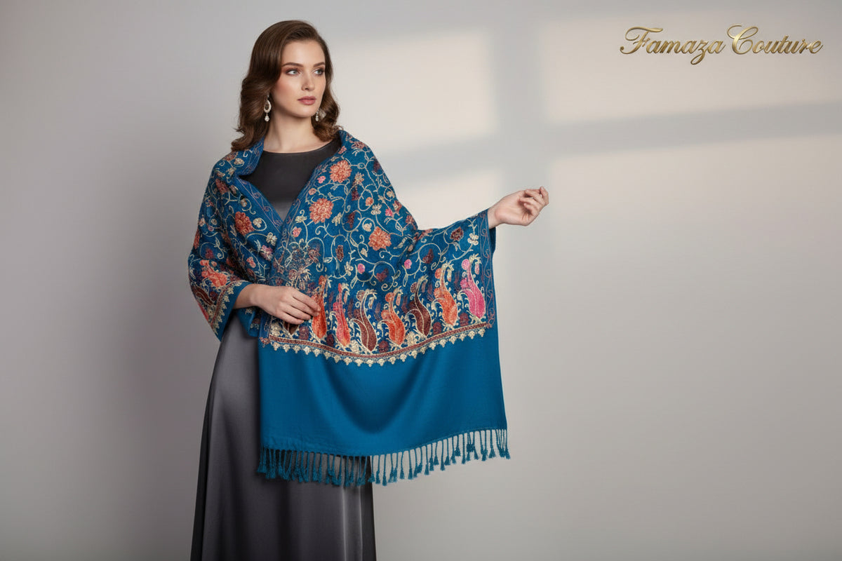 A Teal blue pashmina scarf with Kashmiri Aari embroidery in a floral pattern, featuring tassels on the ends.