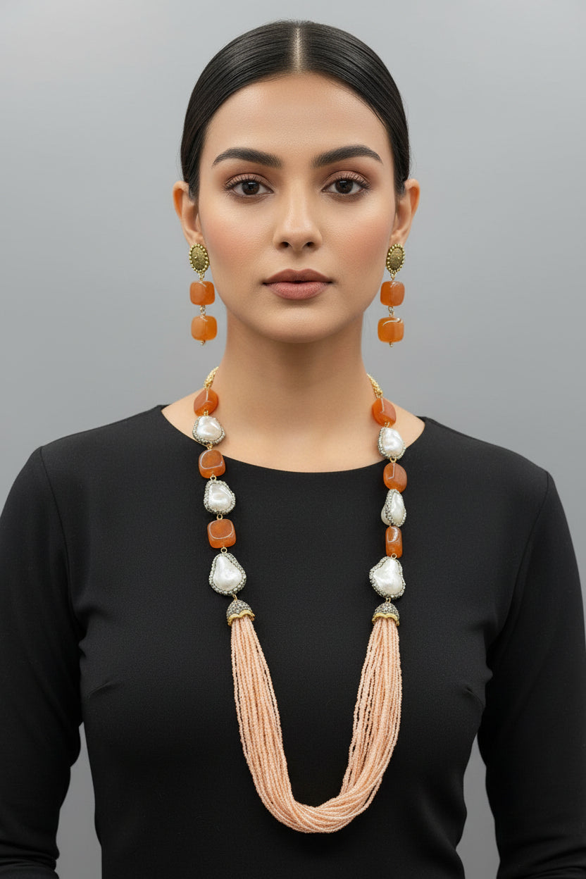 A black mannequin showcasing a Bollywood style Mona Lisa rust colour stone and peach colour nano crystal beaded Mala set, with white colours of beads and gold-tone accents.