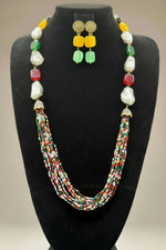 A black mannequin showcasing a Bollywood style Mona Lisa stone and crystal beaded Mala set, with multiple colours of beads and gold-tone accents. Party wear mala set. 