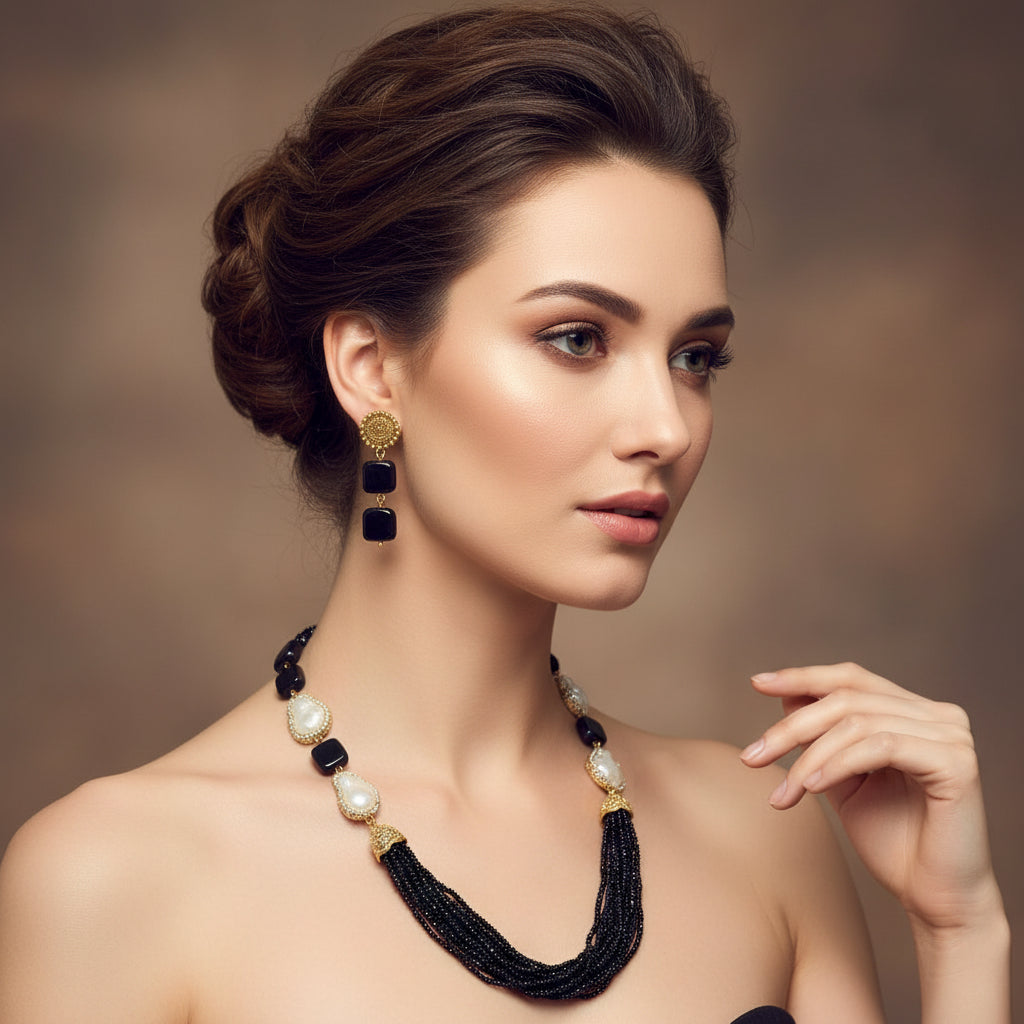 A black mannequin showcasing a Bollywood style black colour Mona Lisa stone and black colour nano crystal beaded Mala set, with white colours of baroque pearls and gold-tone accents. Party wear jewellery set. 