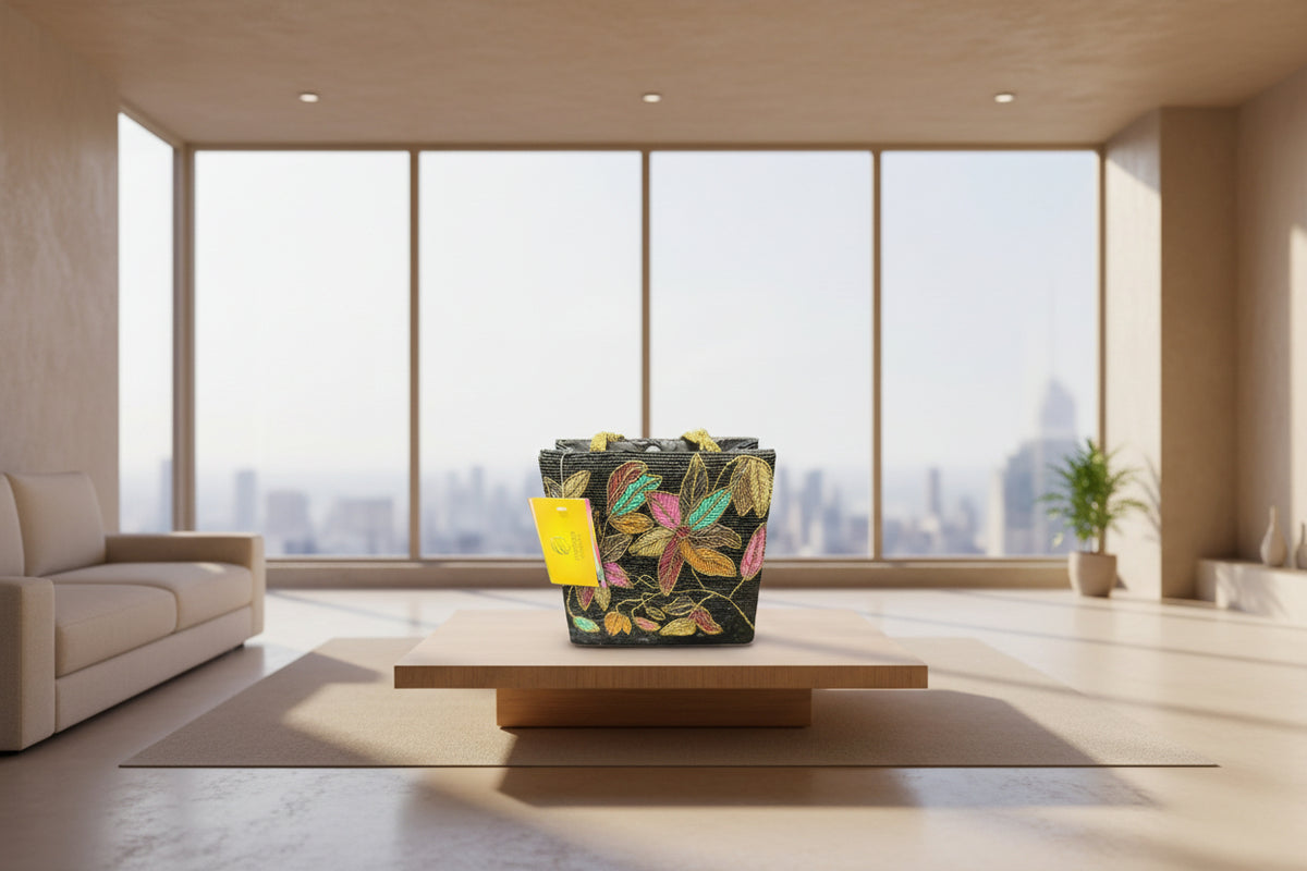 A black silk tote bag with a multi-coloured leaf pattern handcrafted and hand embroidered.