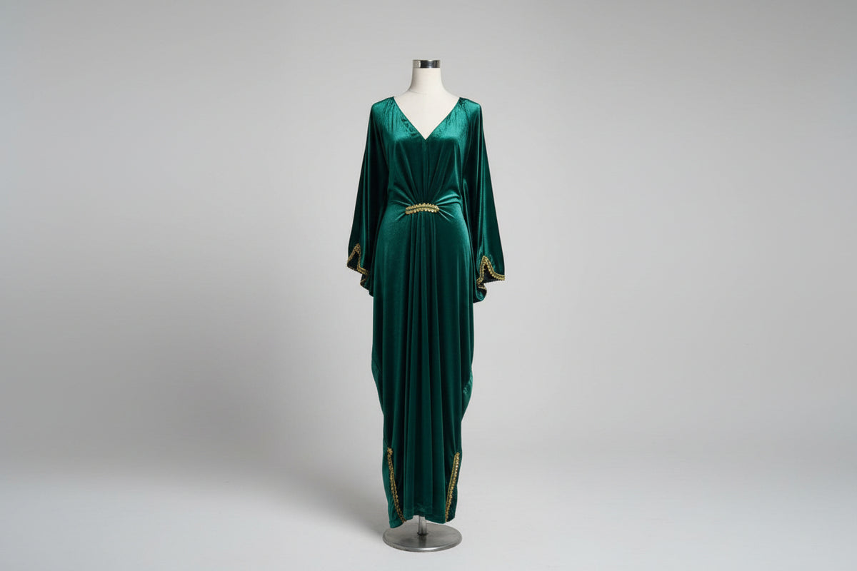 A bottle green kaftan dress displayed on a mannequin, featuring a batwing sleeve design and a V-neckline.