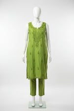 A bright lime green sleeveless embroidered kurta set with matching straight trousers, displayed on white hangers on a clothing rack.