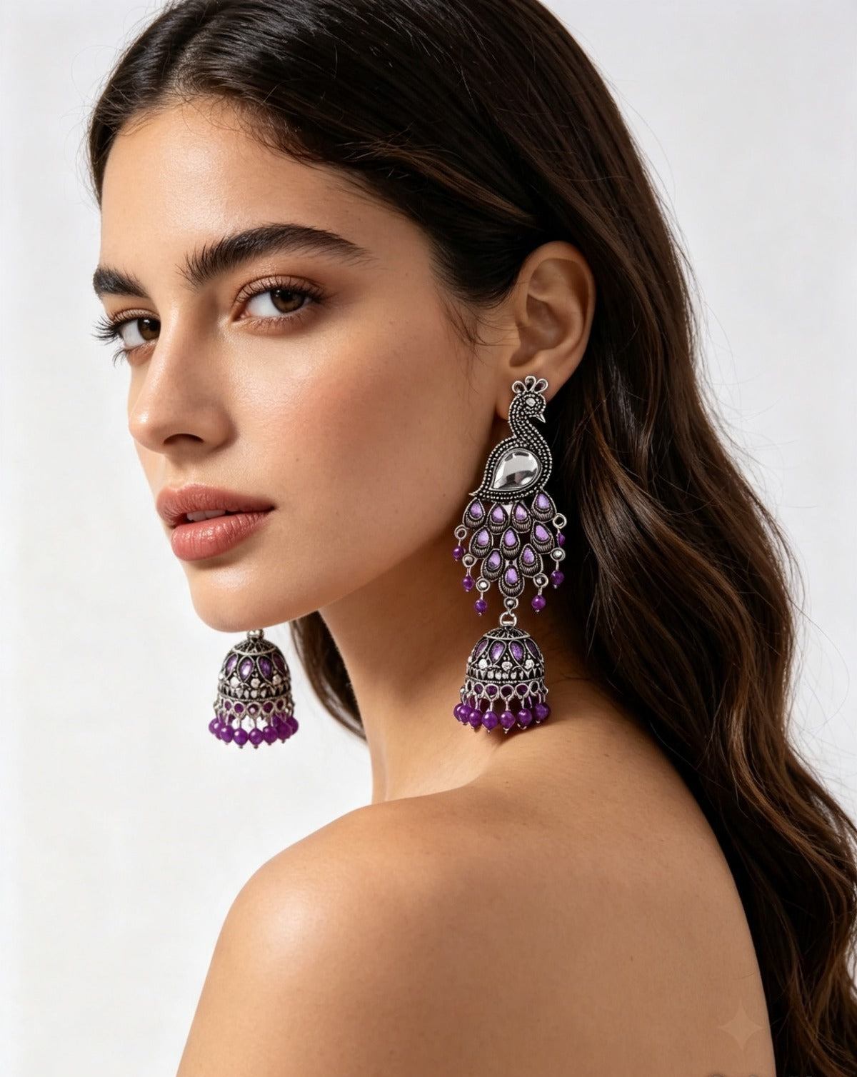 The Royal Mayura oxidised peacock figure jhumka earrings with beaded accents by Famaza Couture