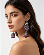 The Royal Mayura oxidised peacock figure jhumka earrings with beaded accents by Famaza Couture